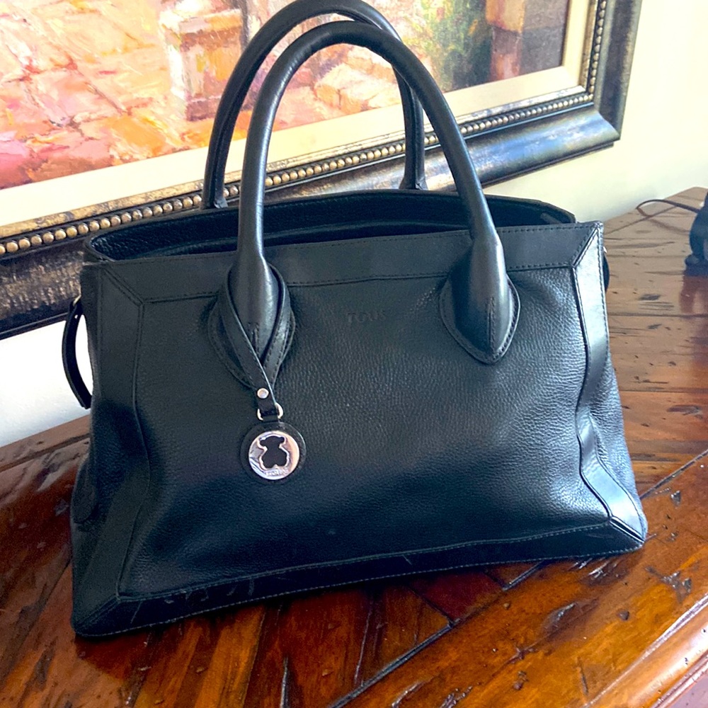 Black leather slightly used TOUS Doctor style handbag with pink lining.